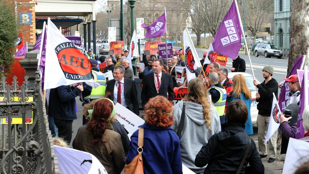 BOMBARDED: State government MPs and staff members had to walk past protesters on their way to Bendigo TAFE. Picture: Peter Weaving