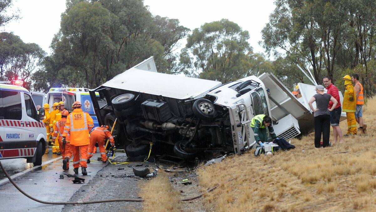WRECKAGE: Police believe bald tyres may have caused the truck to skid out of control in the wet conditions, before coming to rest on its side. Picture: JODIE DONNELLAN