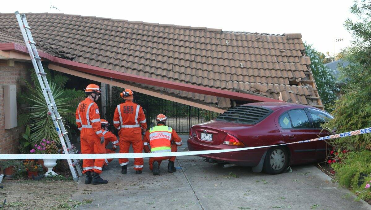 UNSTABLE: SES members inspect the scene of yesterday’s crash in Akoonah Drive, Golden Square. Picture: Peter Weaving
