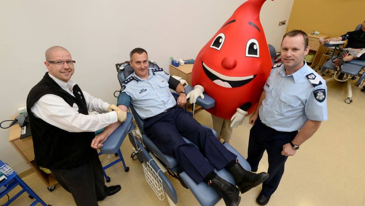 Important gift: Bendigo Blood Bank’s Phil Akeroyd, Inspector Mark Edwards, Billy the blood drop and Senior Sergeant John Dalton at the Bendigo Donor Centre. Picture: Jim Aldersey