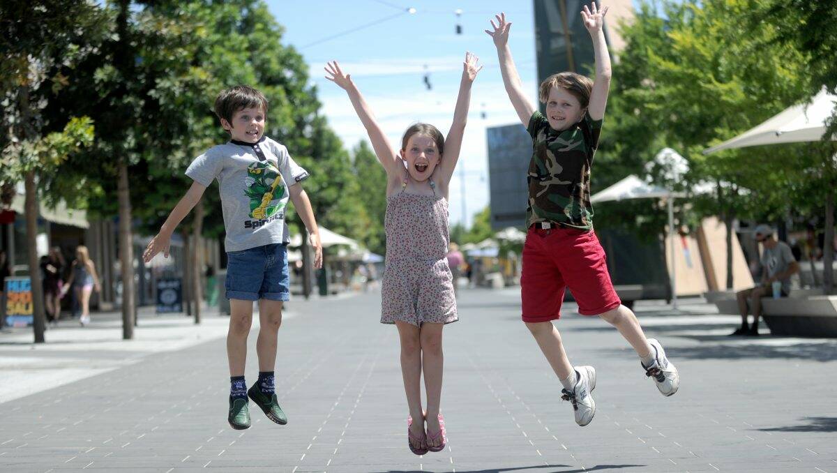 Excited: Eight-year-old Daniel McColl and seven-year-old Sasha and nine-year-old Kieran Waters jump for joy.  Picture: Jodie Donellan