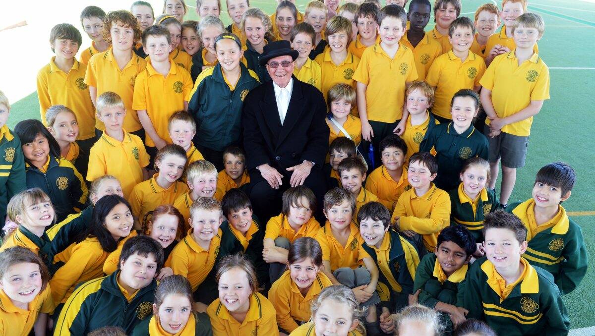 Re-enactment: Jim Evans of the Bendigo Historical Society, dressed as Reverend Backhaus, with students at St Kilian’s Primary School. Brendan McCarthy