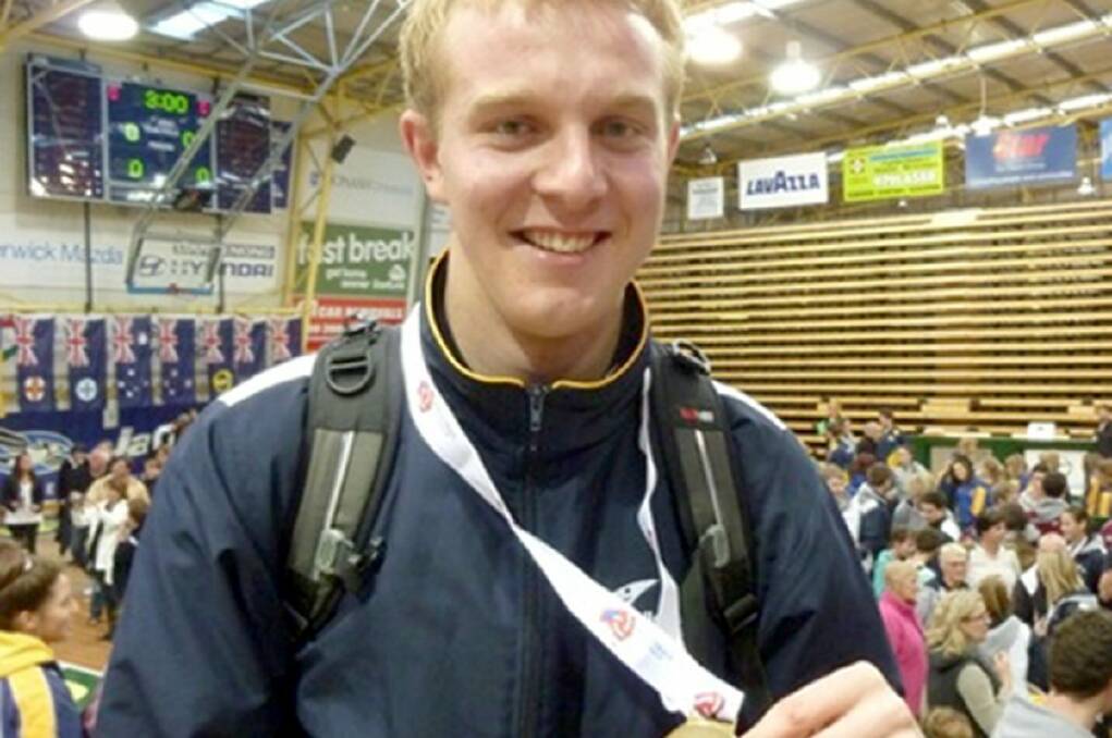 ELATED: Todd Broadbent holding a gold medal won at the Volleyball national titles.