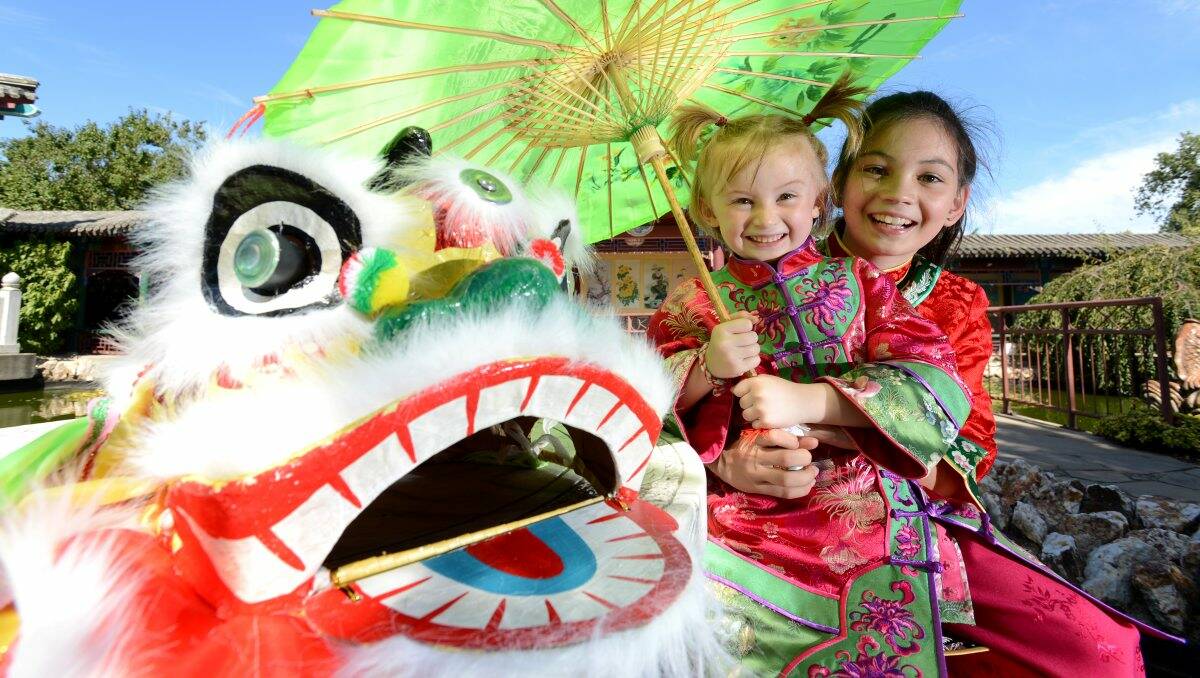 Festive: Amelita, 4, and Stellina Baxter, 10, at the Chinese Museum gardens. Picture: Jim Aldersey