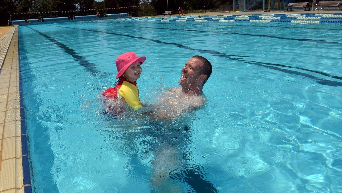 HEAT BEATER: Rob Baker and daughter Ella, 2, cool off at the Bendigo Aquatic Centre. Picture: BRENDAN McCARTHY