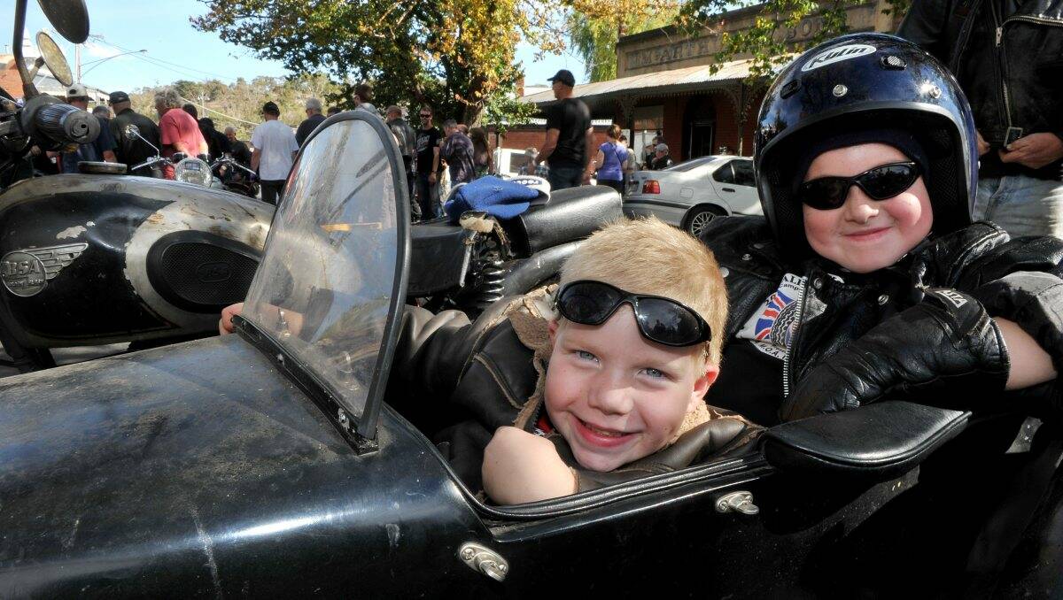 Frankston brothers Rex (right) and Ned Eldridge hitch a ride in their dad’s sidecar. Picture: Julie Hough