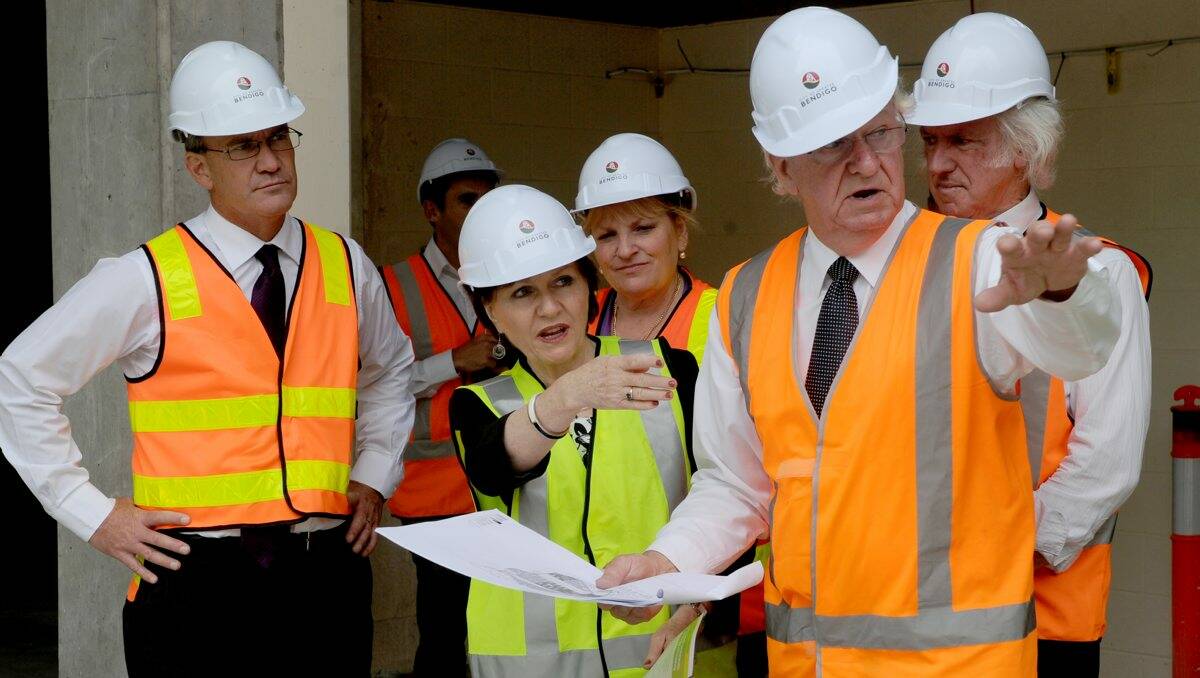 ON TRACK: Minister for Local Government Jeanette Powell (centre) tours the library redevelopment with City of Greater Bendigo chief excutive officer Craig Niemann and architect Bob Goldsworthy. Picture: JODIE DONNELLAN 