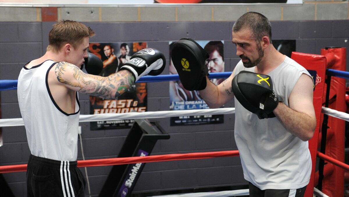 STRIKE: Danny Taggert in training with Olympic boxer Lynden Hosking at SupaBox. Pictures: PETER WEAVING