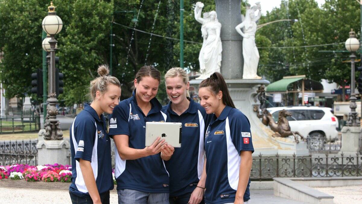 SNEAK PEEK: Bendigo Spirit players Maddie Garrick, Kelsey Griffin, Chelsea Aubry and Renae Camino take a look at the Addy’s new online Spirit page being launched today. Picture: PETER WEAVING 