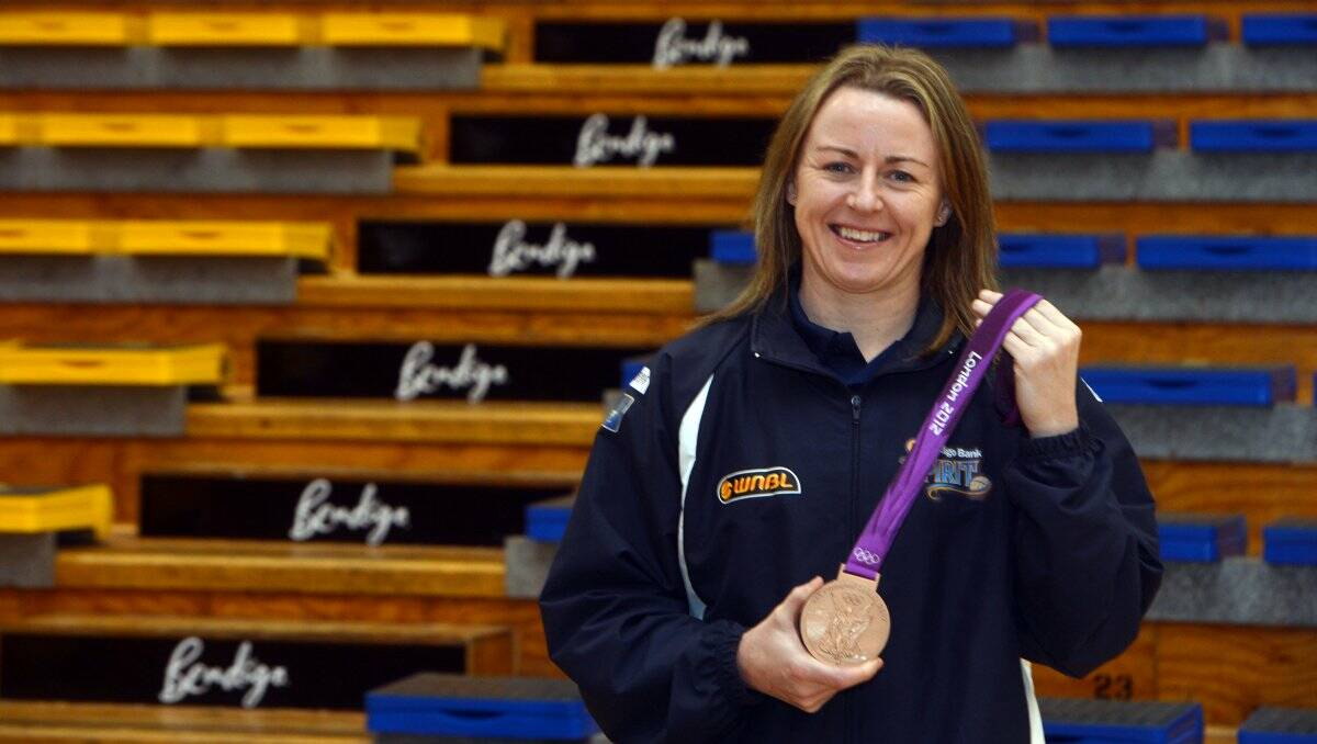 SUPERSTAR: Bendigo's basketball champion Kristi Harrower with the bronze medal she earned at this year's London Olympics. Picture: BRENDAN McCARTHY;