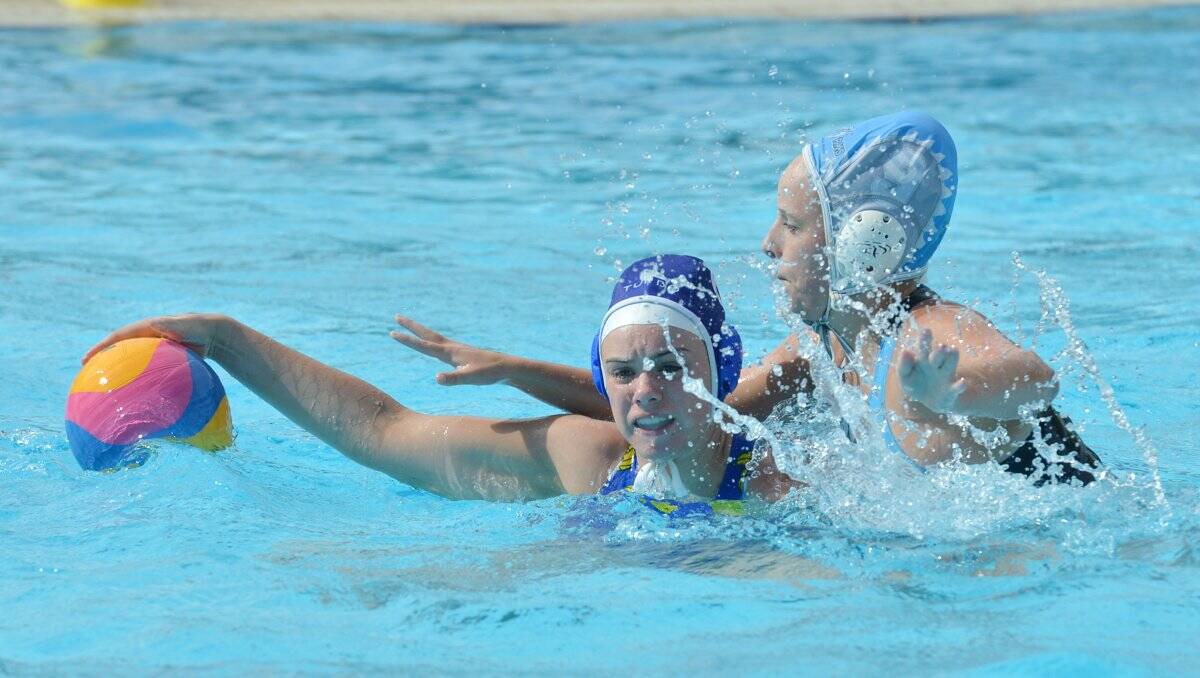 CONTEST: Bendigo's Olivia Arandt fights to keep possession in home waters at the Bendigo Aquatic Centre. Picture: JULIE HOUGH 