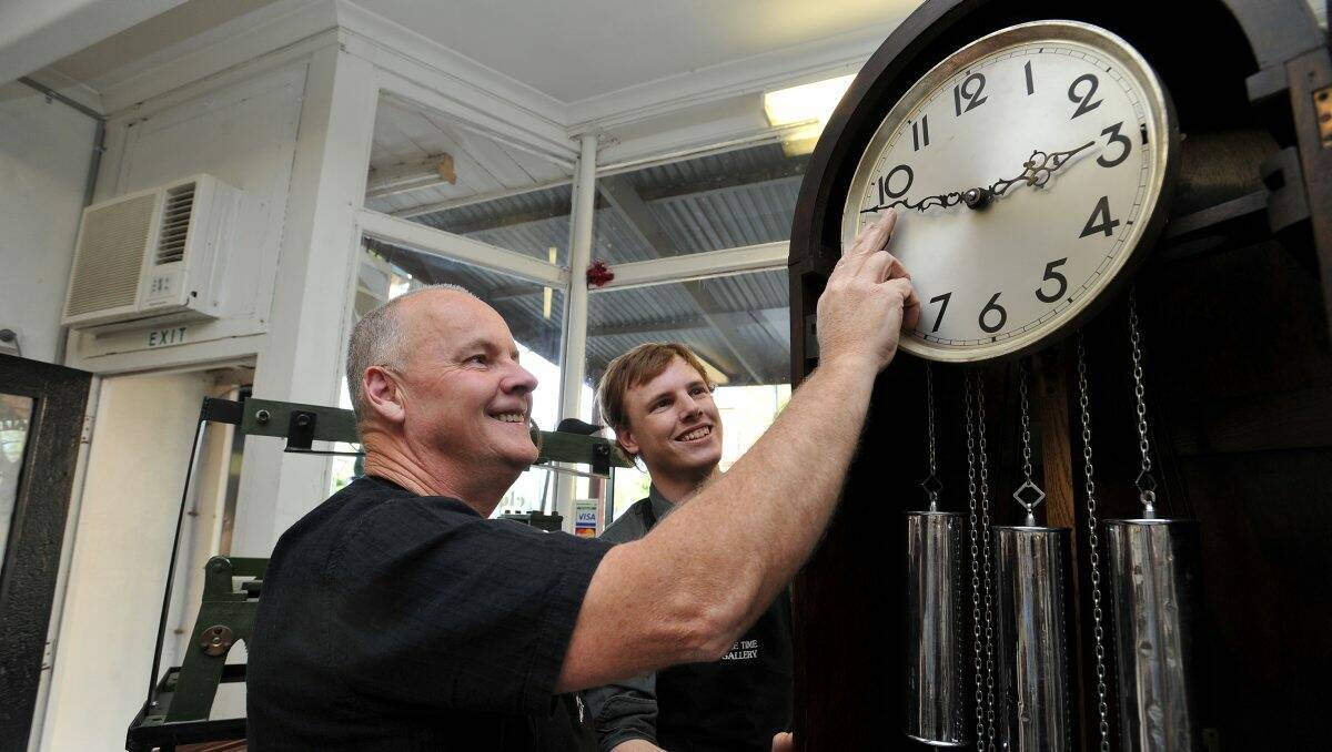 John and his son Justin Allott from The Time Gallery get ready for daylight savings.