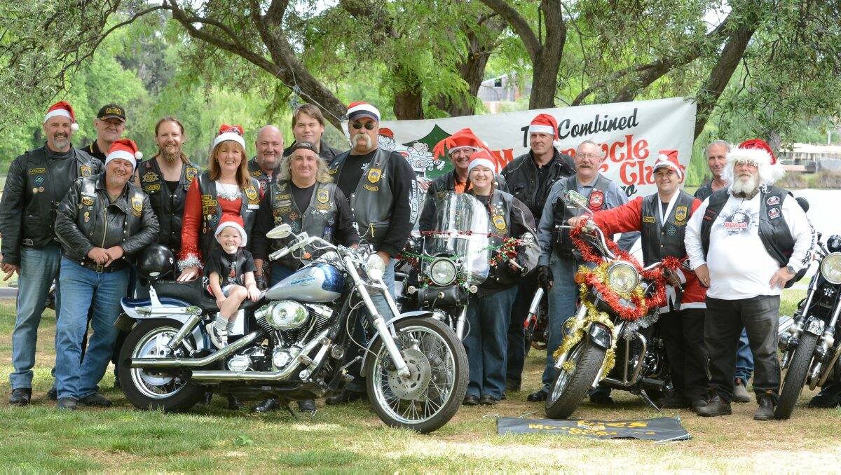 Liam Welsh, 5, with members of the Allies Motorcycle club before their Christmas toy run. 
