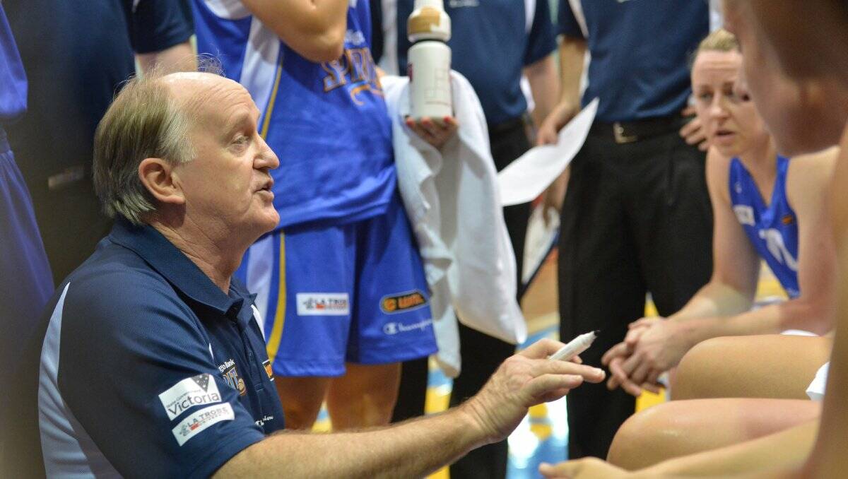 WORDS OF WISDOM: Bernie Harrower talks to the Bendigo Spirit line-up during a time-out. Picture: JULIE HOUGH 