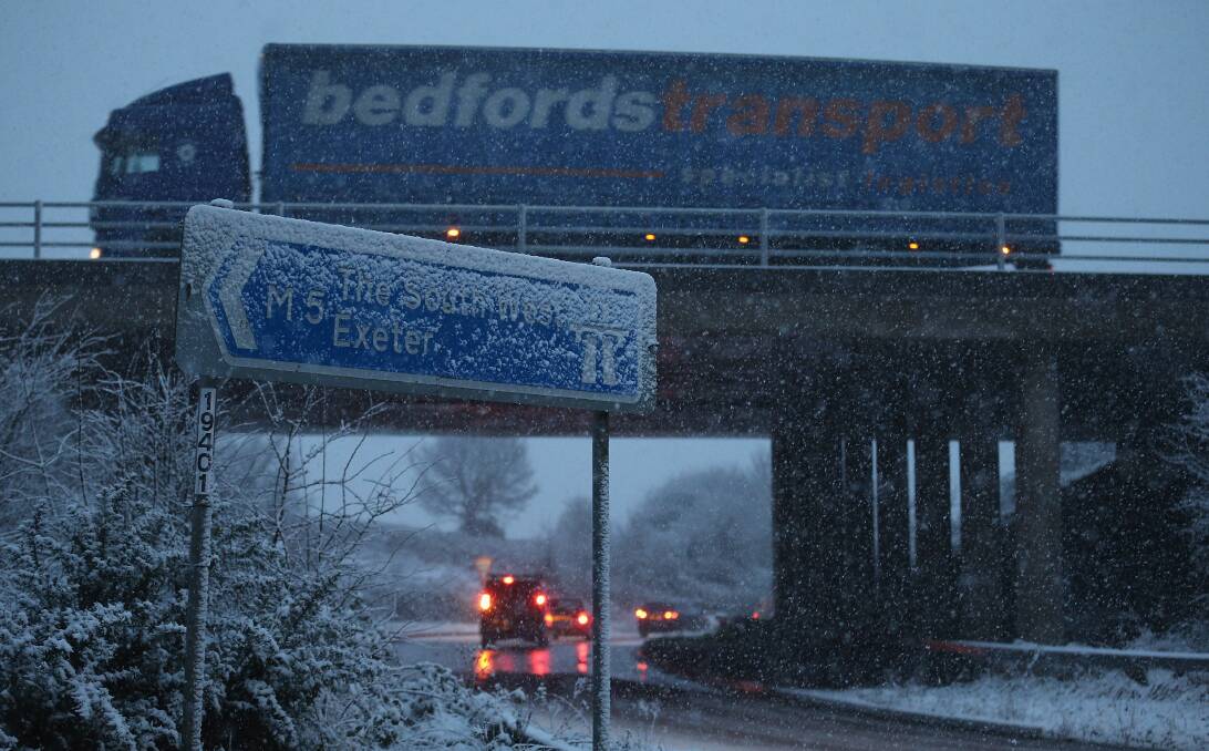 Vehicles make their way around Junction 26 of the M4 motorway as snow falls near Wellington, England. Photo by Matt Cardy/Getty Images