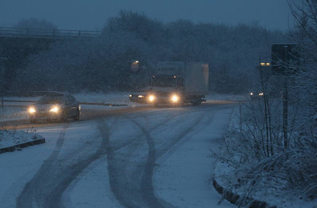 Vehicles make their way around Junction 26 of the M4 motorway as snow falls near Wellington, England. Photo by Matt Cardy/Getty Images
