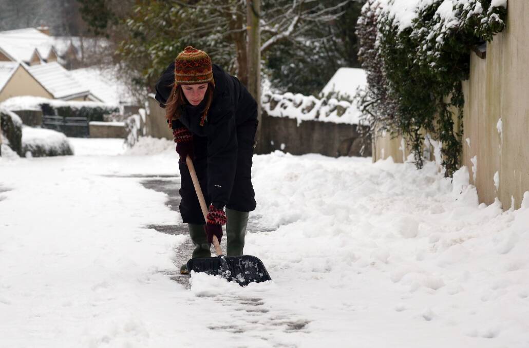 Residents clear snow on a road near Holcombe on January 22, 2013 in Somerset, England. Photo by Matt Cardy/Getty Images