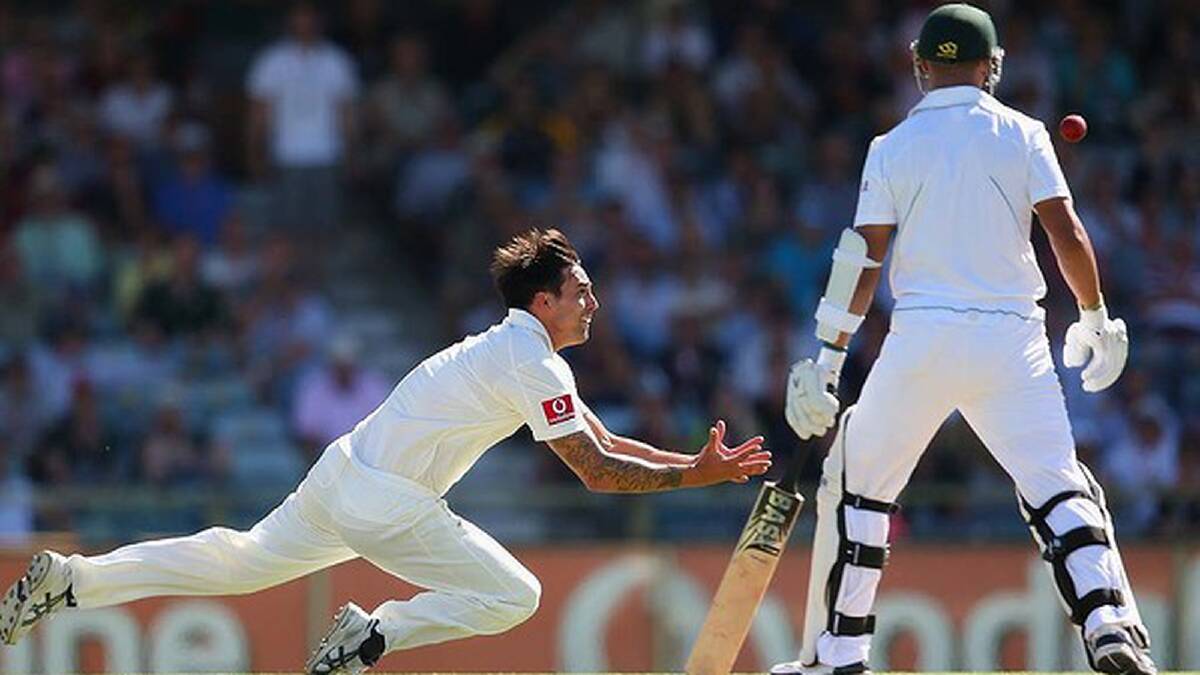 Alviro Petersen catches the leading edge, but looks safe. But Mitchell Johnson charges in his follow through... Photo: Getty Images