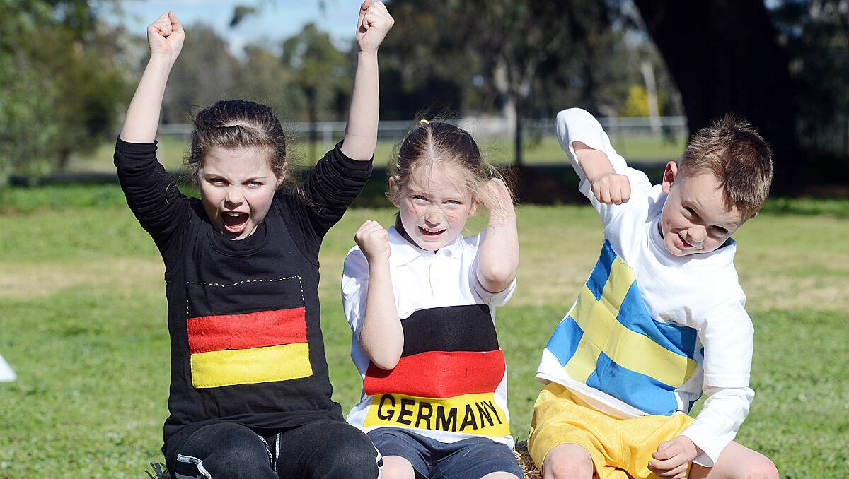 Esther McCrohan grade 2, Mackenzie Anderson prep and Jimmy Tuohey grade 1 from Goornong Primary School dressed up in team colours for the schools mini Olympics. Photo Jim Aldersey