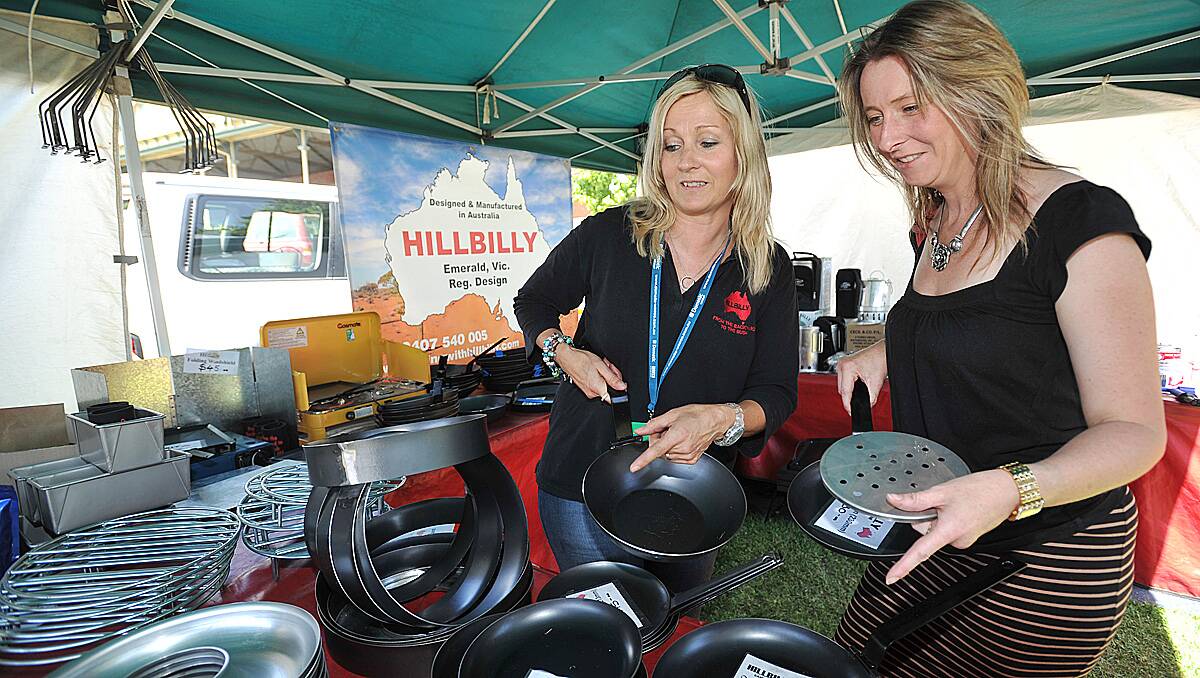 Belinda Mills (L) from Hillbilly Camping in Emerald shows her wares to Strathfieldsay's Janine Butcher