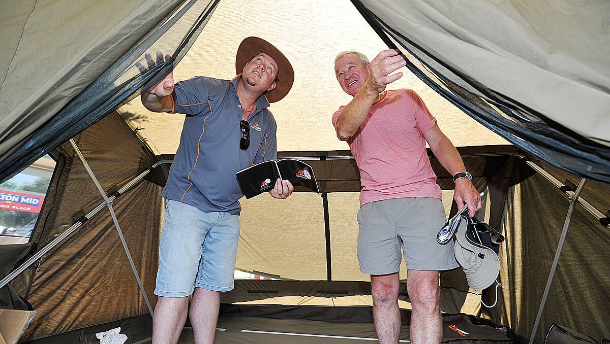 Darren Grossman from 'Oz Tents ' in Harrietville (L) shows Bendigo's Jeff Torpy through one of his tents.