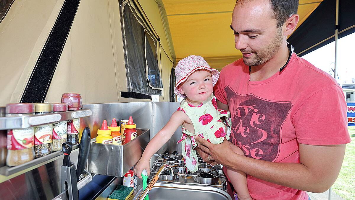 Matt Bender and his 18 month old daughter Charlee from Lancefield check out a camper trailer