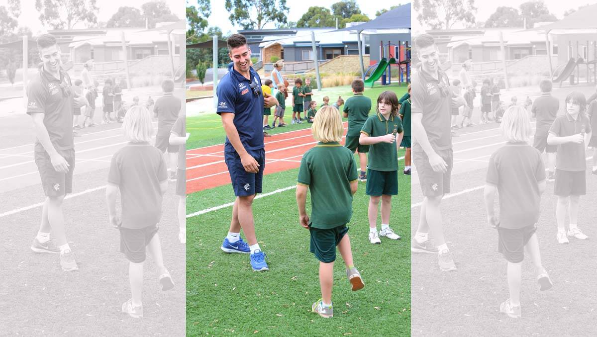 Luke Mitchell talks with Bailey Hales at the Carlton Football clinic. Picture: Peter Weaving
