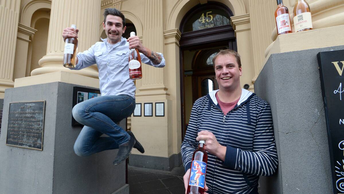 JUMPING FOR JOY: Celebrating the growing popularity of rosé are Sam Bowman and Ash Raeburn from Bowman Wines with their rosé and a selection of other regional rosé wines. Picture: Jim Aldersey