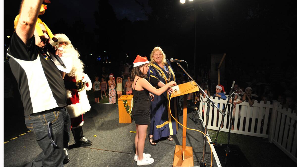Winner of the 'flick the switch' competition Olivia Foster turns on the lights. Picture: Jodie Donnellan