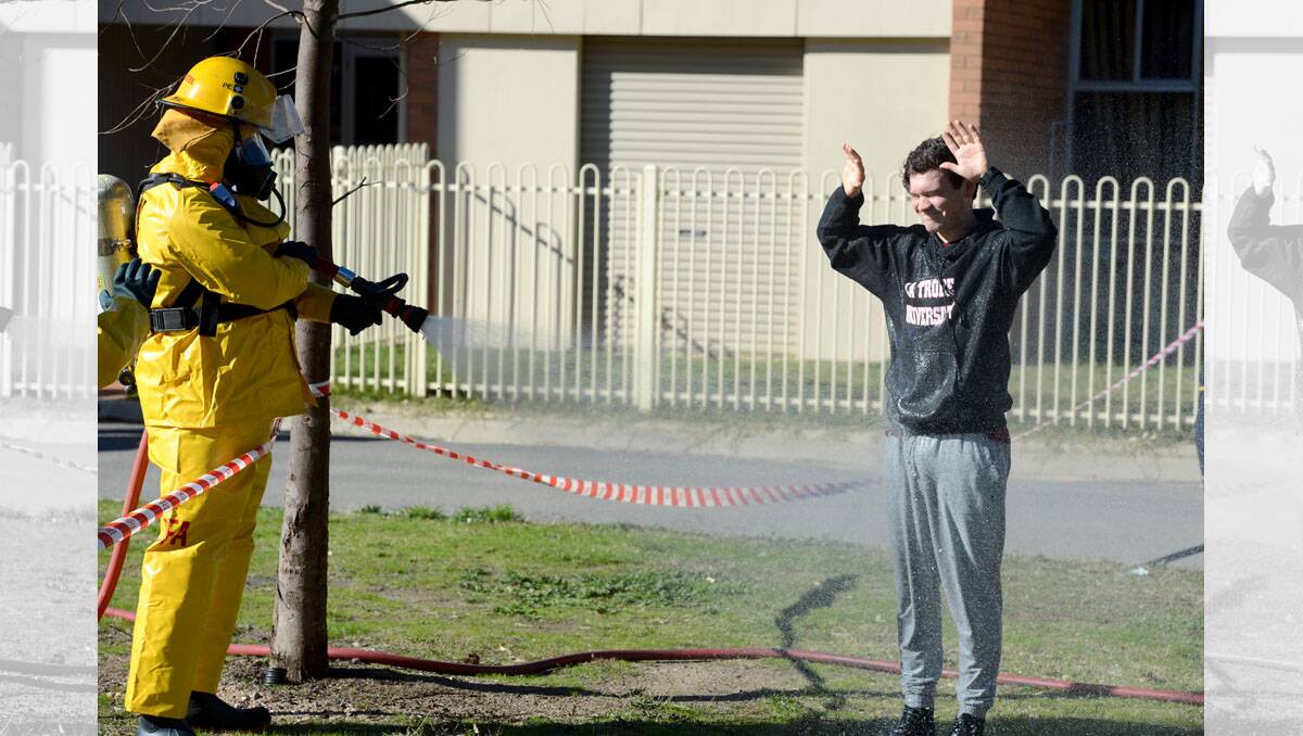 La Trobe student Eliot Walton gets Decontaminated by the CFA during the exercise. Police, CFA, Paramedics and SES attend a Terrorism Training exercise in Kangaroo Flat with the help of local students. Picture: JIM ALDERSEY