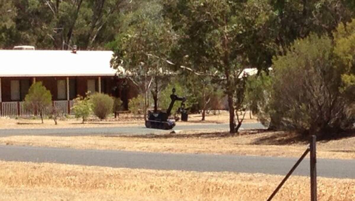 The bomb squad's robot heads off to collect the item. Picture: Josh Fagan