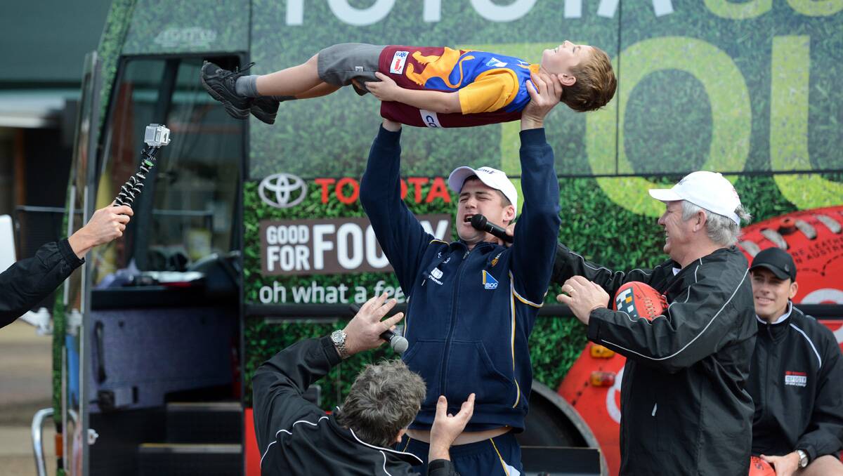 AFL Legends Footy Clinic at St Therese's Primary School. Jonathon Brown shoulder presses Myles Livingstone. Picture: Jim Aldersey