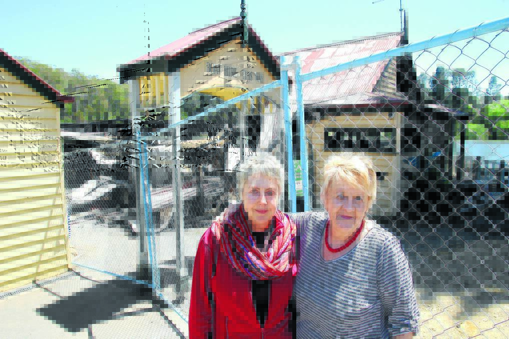 RESILIENT: Karen Harman and Julia Meere inspect the damage at the Boathouse cafe, which was destroyed by fire on Saturday night. Picture: PETER WEAVING