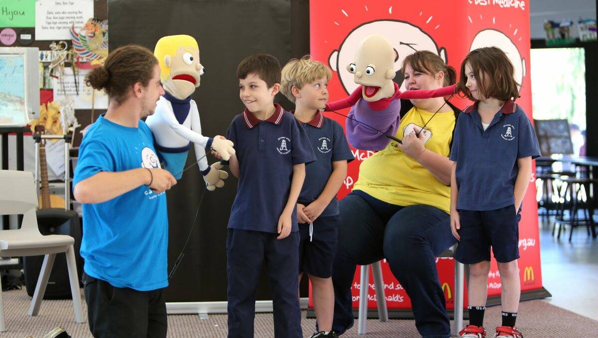 LAUGHTER: Camp Quality puppeteer Tim Sneddon with Quarry Hill Primary students Edward, 9, Sam, 9, and Levi, 9. Picture: PETER WEAVING