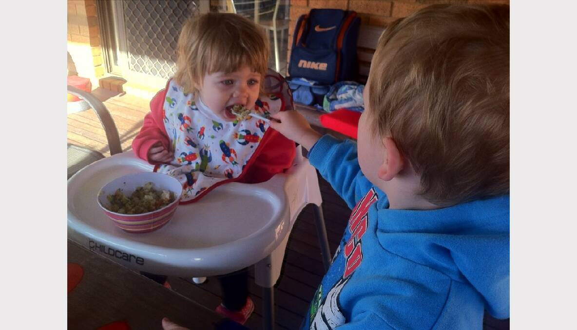 Connor Kane (3) helps feed his cousin Rachel Yorston (20-months) at nan and pa's house. Picture: Rebecca Ruiter