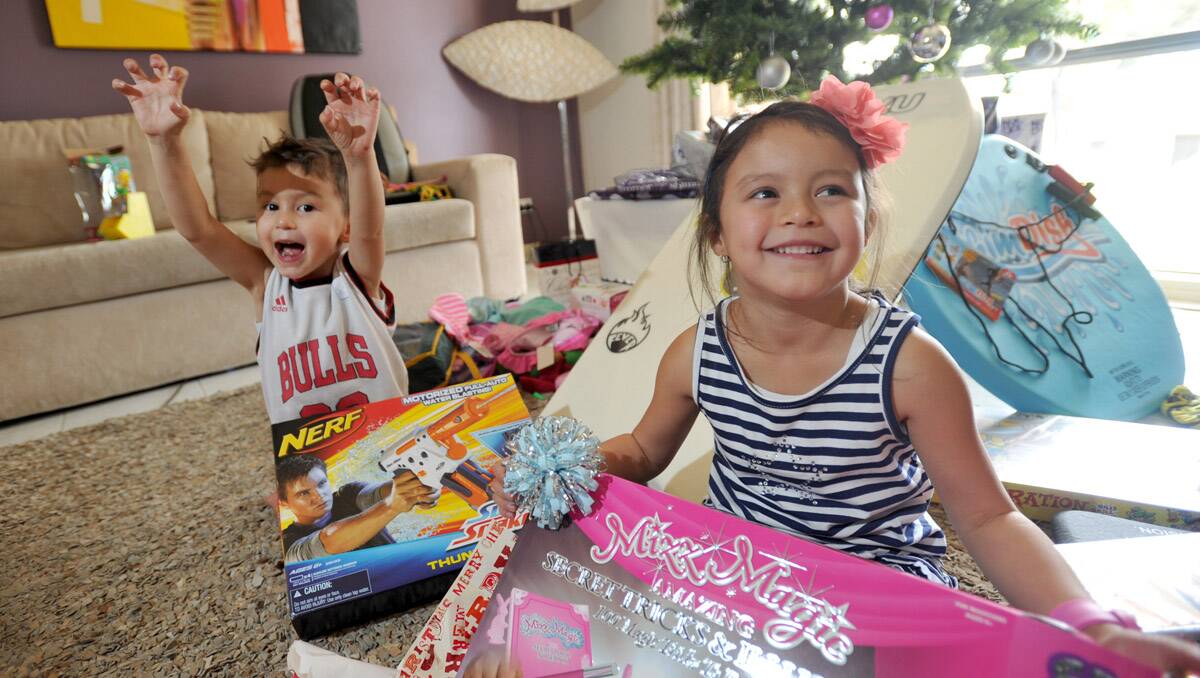 Jarvis, 3 and Allegra Mahon, 5 open up presents on Christmas morning. Picture: Jodie Donnellan