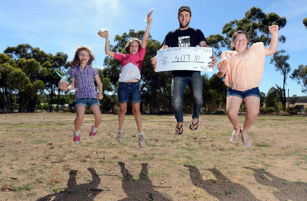 GENEROUS: Eppalock Primary School students Jessica Gallagher, Nicole Gallagher and Nikiah Ratcliffe raised $409.70 for Luke Owens’ homeless youth fund-raiser. The girls also made their own novelty cheque to present to Luke. Picture: JIM ALDERSEY