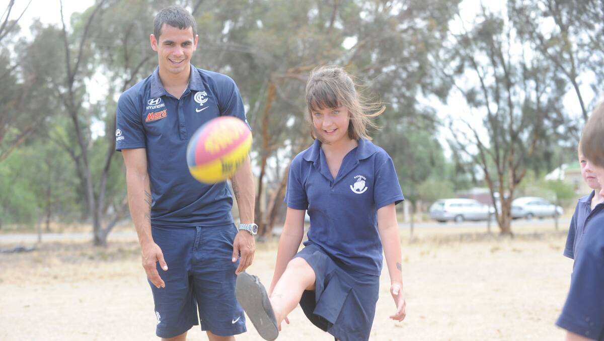 Carlton players visit Raywood Primary School. Jeff Garlett with Paige Wilson. Picture: Jodie Donnellan