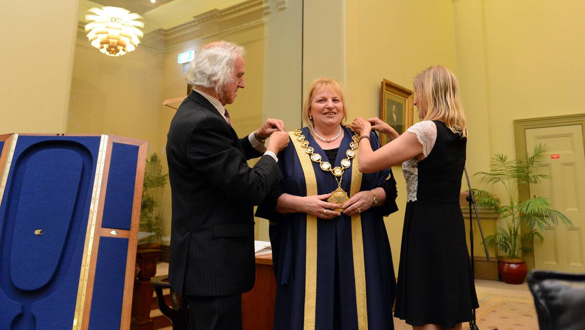 Rod Fyffe and Elise Chapman help Lisa Ruffell with her mayoral robes. Picture: Jim Aldersey