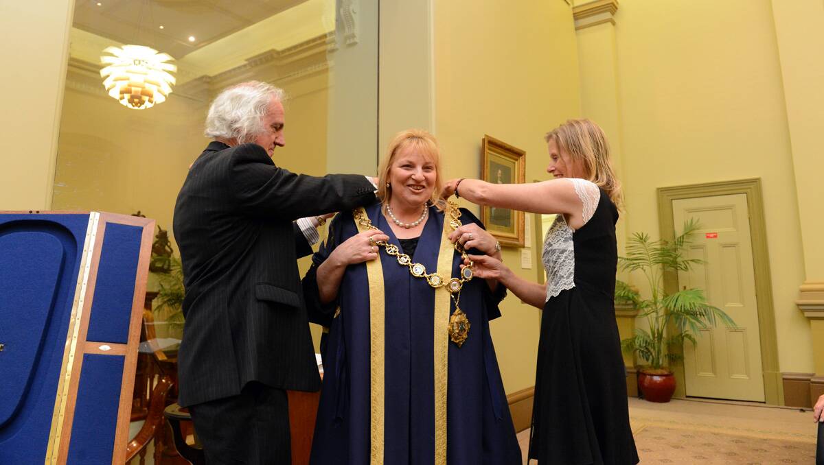 Rod Fyffe and Elise Chapman help Lisa Ruffell with her mayoral robes. Picture: Jim Aldersey