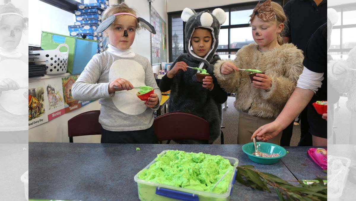 Camp Hill PS with Preps at their 100 days party day. Emily Edwards, Sage Wall and Seren Smith ice their cakes. Picture Peter Weaving