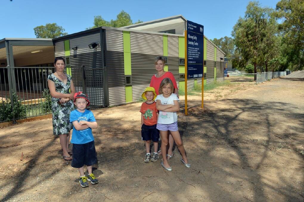 UNHAPPY: Parents Tammy Parkes and Emma Power with children Zac, 5, Sam, 5, and Laura, 7. Picture: Brendan McCarthy