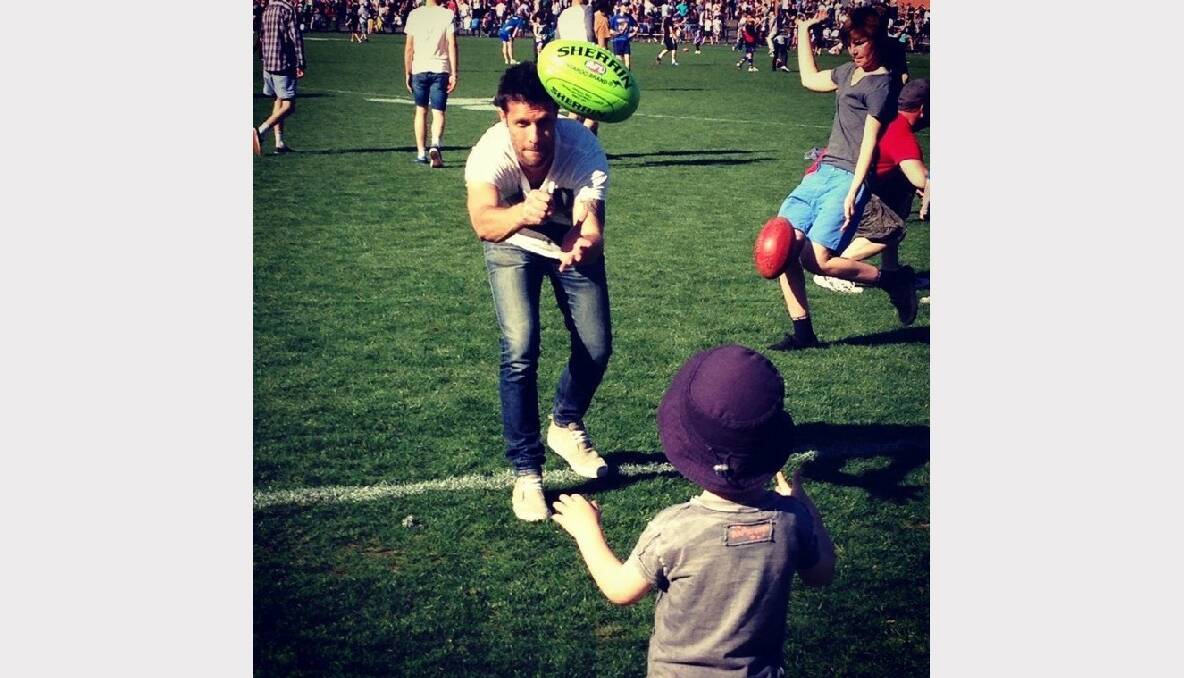 Nathan Claridge hand passes to his son Max during half time at the BFNL Grand Final. Picture: Bruce Claridge
