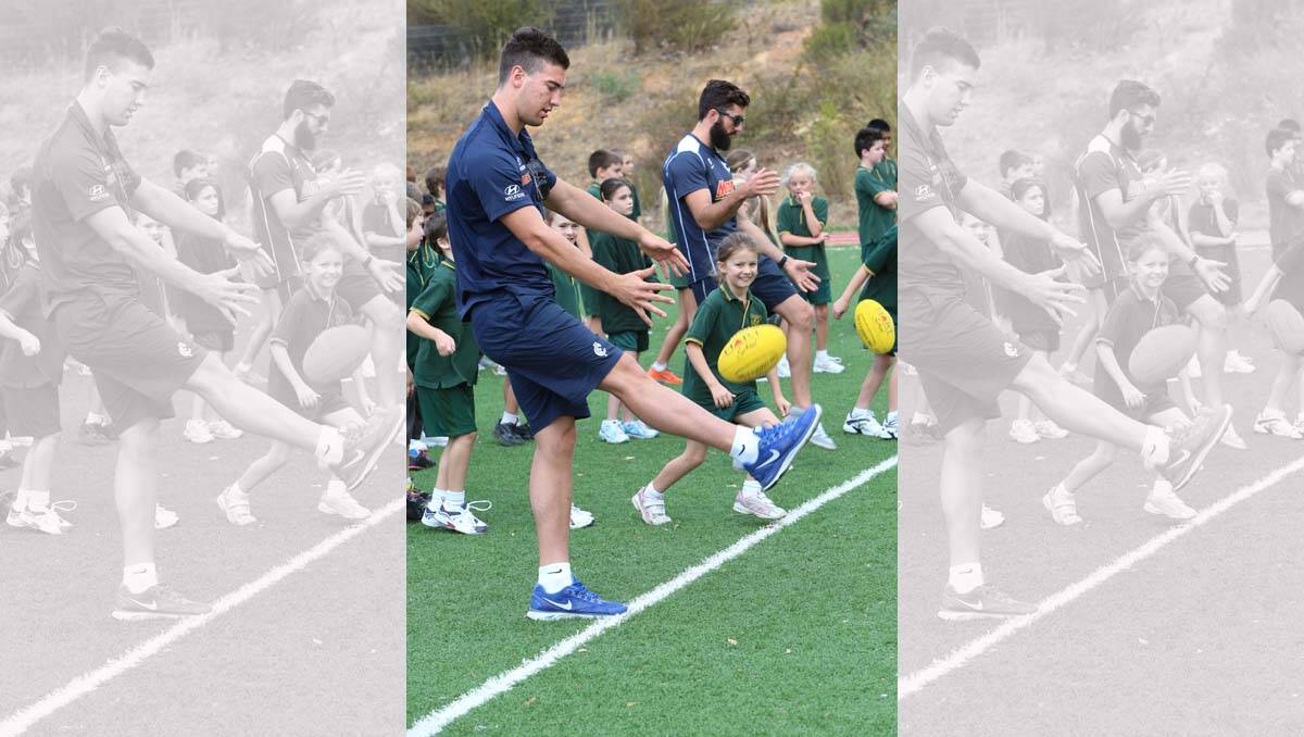 Luke Mitchell and Kade Simpson at the Carlton Football clinic. Picture: Peter Weaving