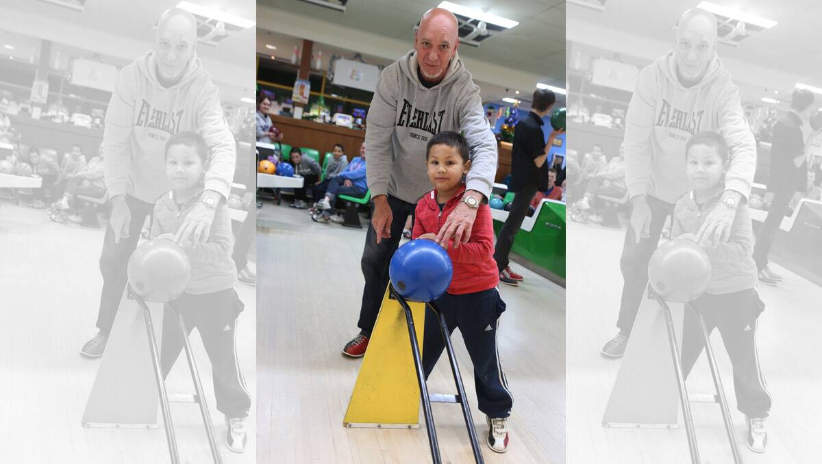 Dragon City Lanes, lanes are full during the school holidays. Jai munro 5 gets some help from step dad Mark Brown from Swan Hill. Pictures: Peter Weaving 