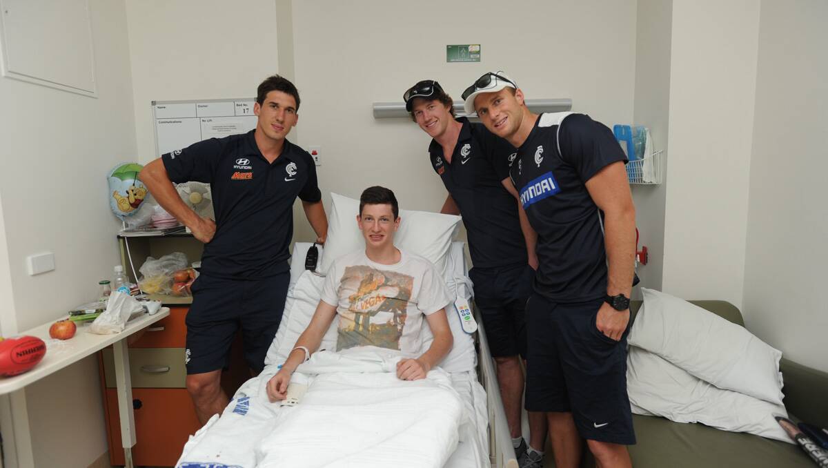 Carlton players visit Bendigo Health. Michael Jamison, Sam Rowe and Lachie Henderson visit Ben Byrne. Picture: Jodie Donnellan