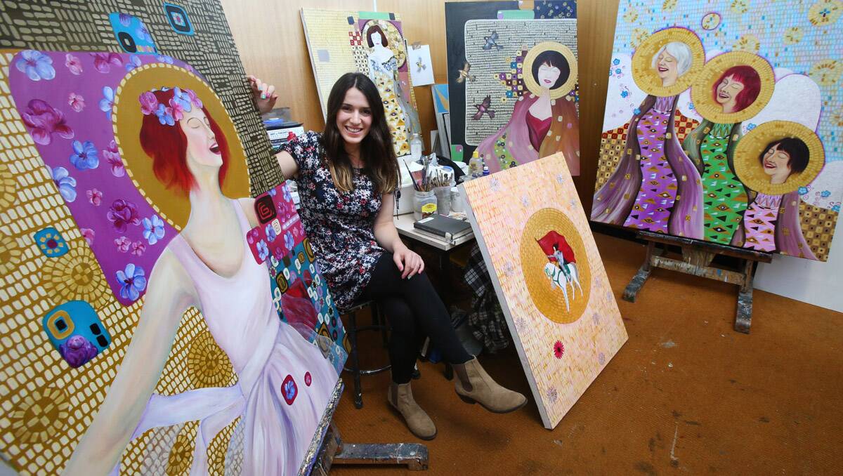 Alana Brand is an honor students at La Trobe University. She has painted a portrait of Julia Gillard and other people she admires. She wants to give Julia her portrait.  Picture: Peter Weaving