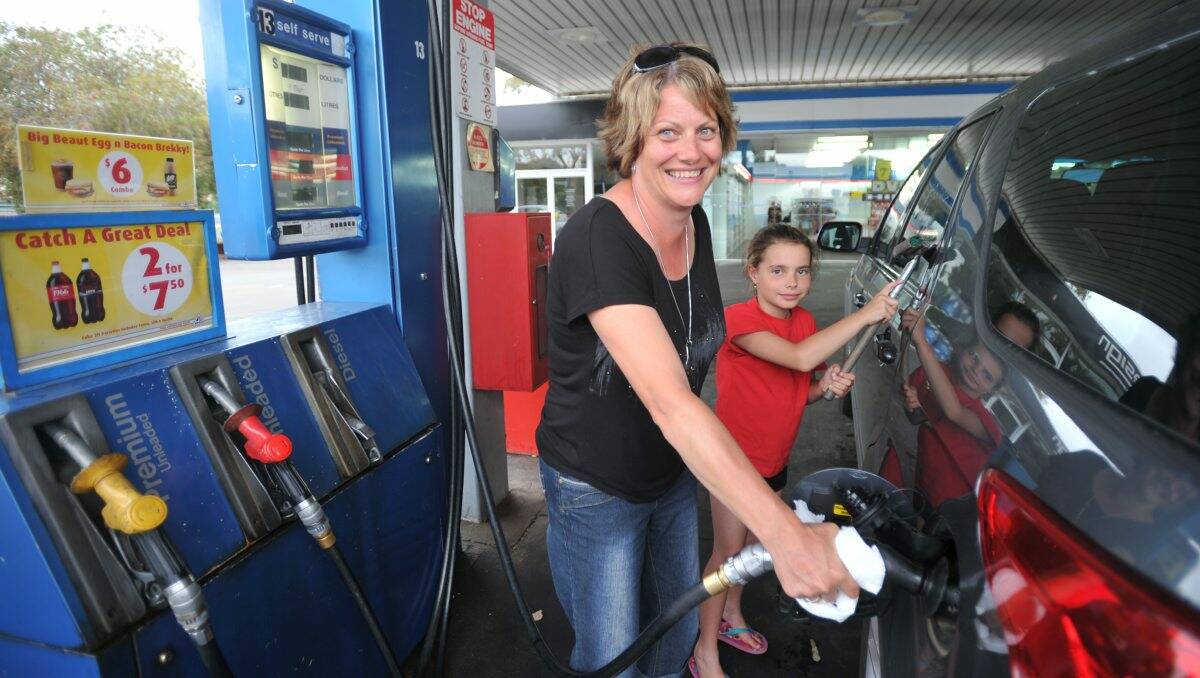 Short supply: Trish Hall, pictured with daughter Chloe, was one of the lucky ones able to fill up her car yesterday.  Picture: JODIE DONNELLAN