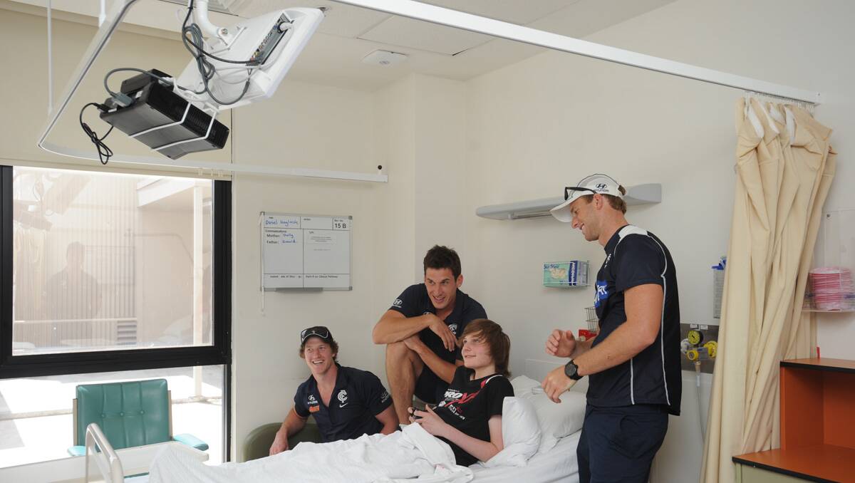 Carlton players visit Bendigo Health. Sam Rowe, Michael Jamison and Lachie Henderson visit Daniel Haylock. Picture: Jodie Donnellan
