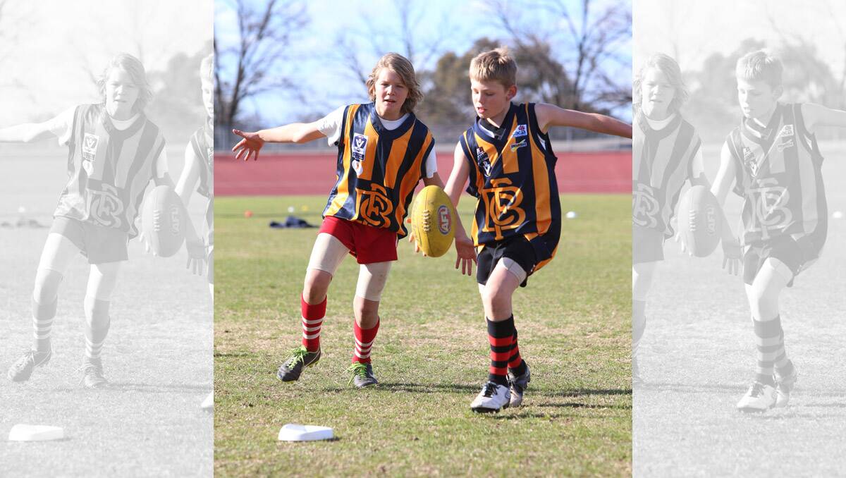 Holiday footy clinic at Tom Flood Centre. Erasmus Koska and Ben Sherriff kicking. Pictures: Peter Weaving  030713